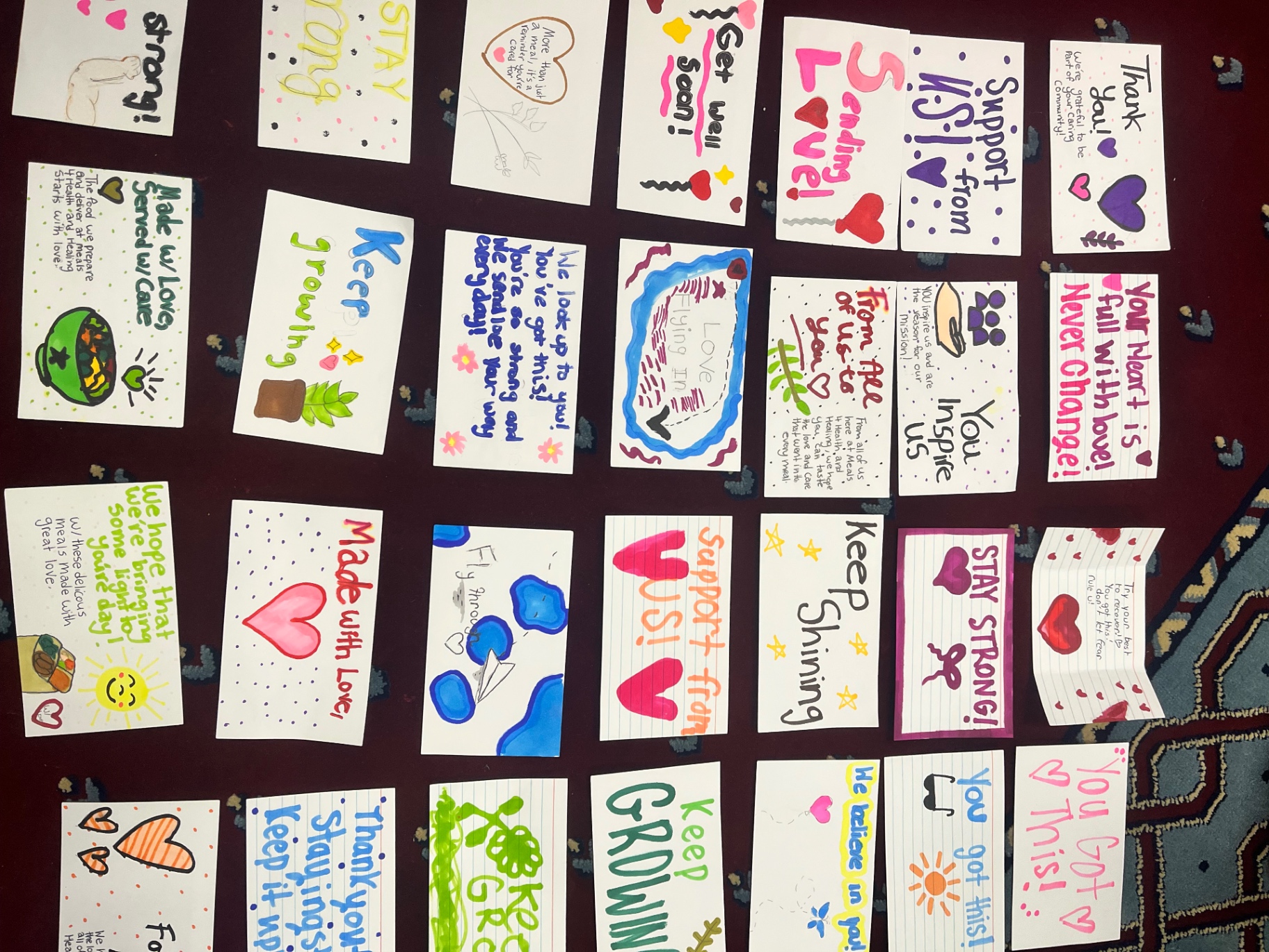 A wall of colorful handwritten notes from student volunteers