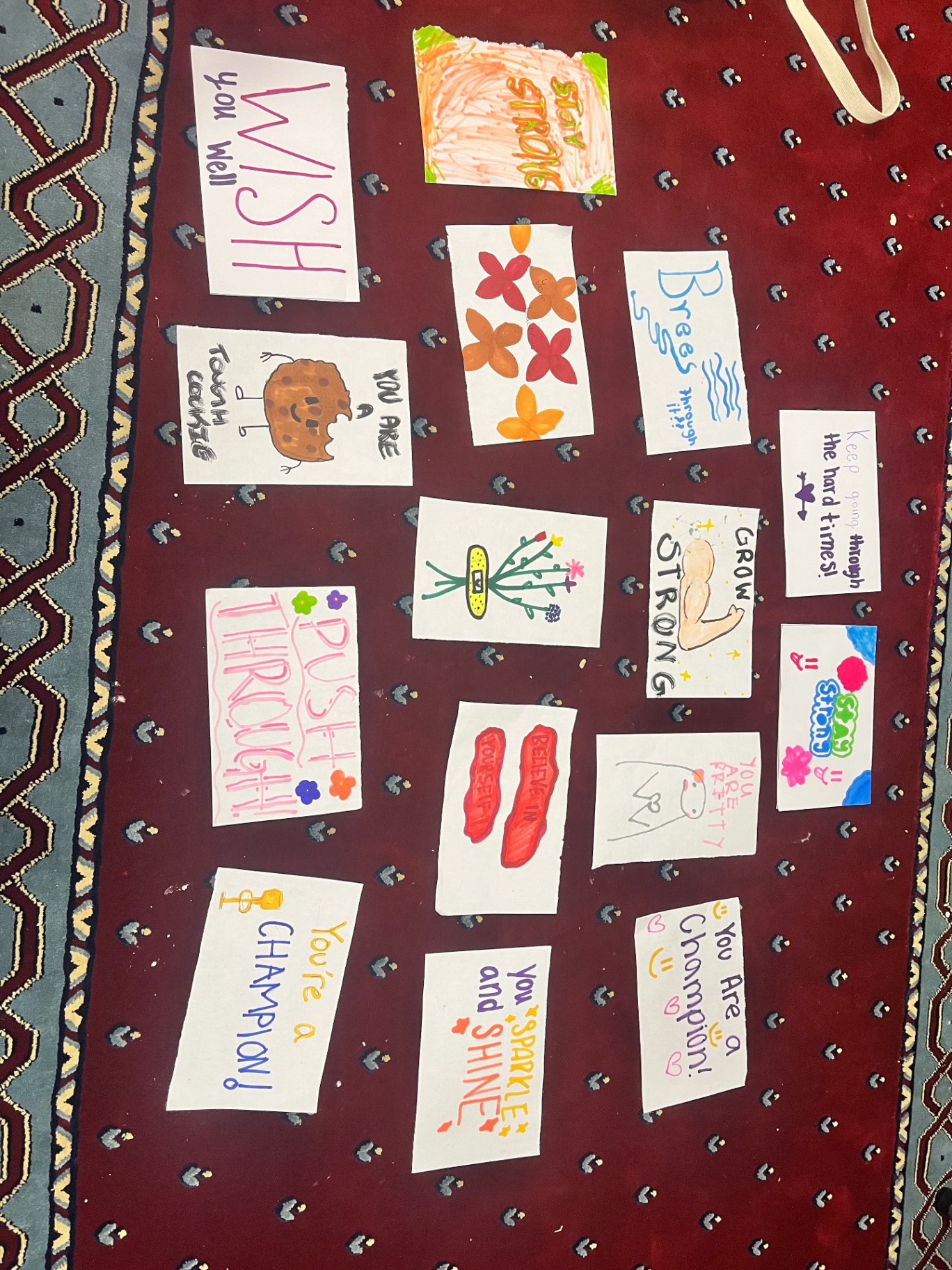 Encouragement cards laid out on a patterned rug